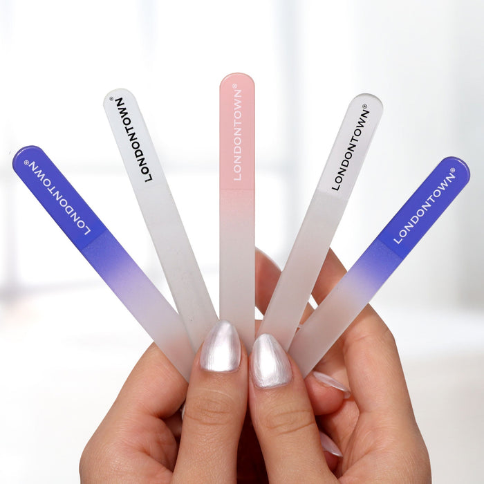 A pair of hands holding five LONDONTOWN Glass Nail File - Black with gradient colors, demonstrating an effortless, damage-free nail filing experience.