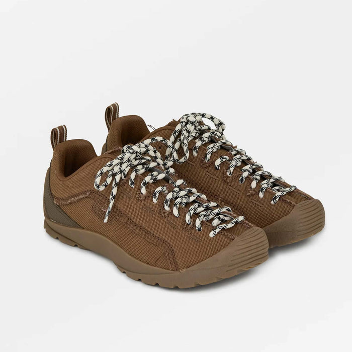 Brown hiking shoes with white laces on a light gray background