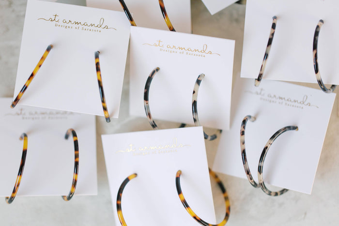 Skinny blonde tortoise hoop earrings by St Armands Designs of Sarasota, featuring lightweight, stylish tortoise pattern hoops.
