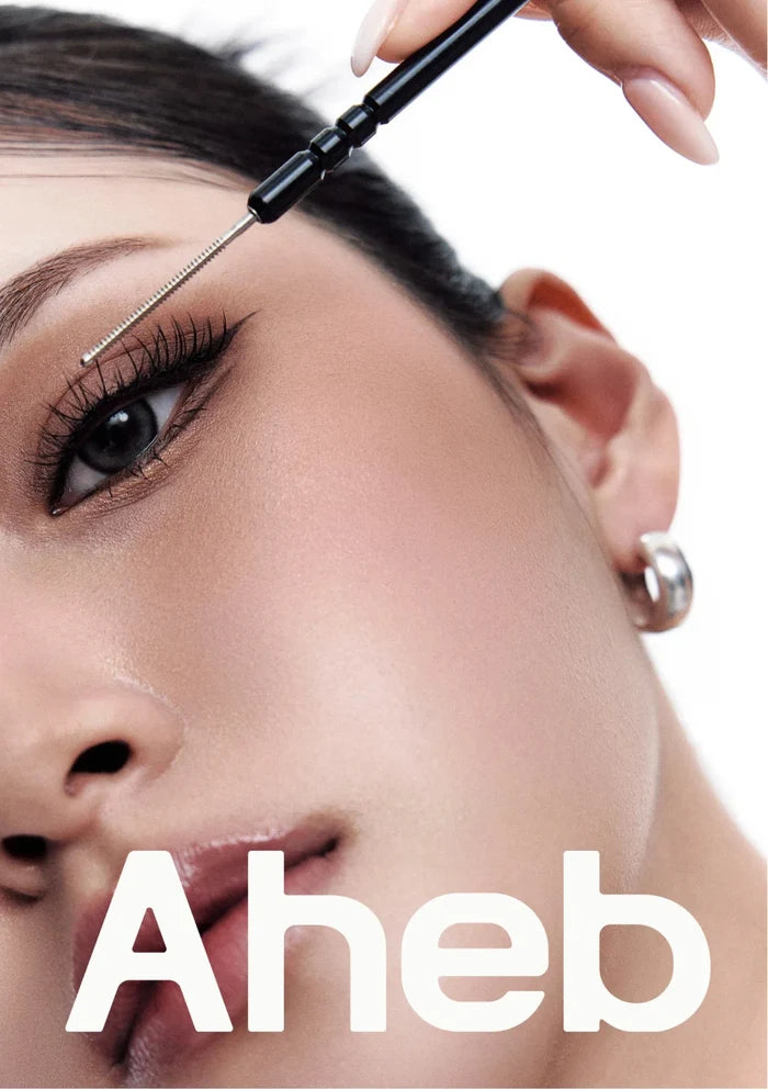 AHEB lash styling tool being used to shape and define eyelashes