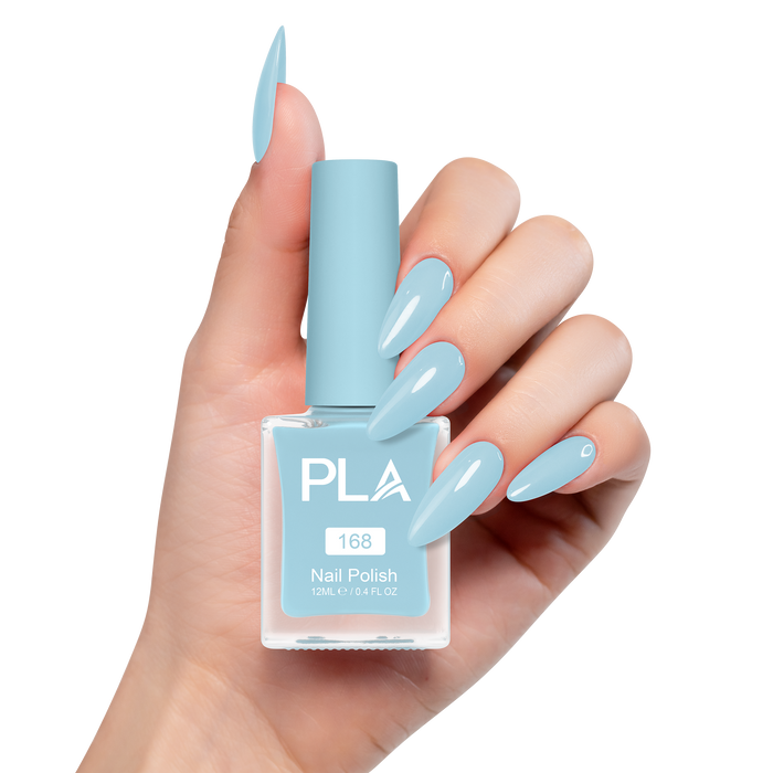 Hand holding a bottle of light blue nail polish with matching nails on a white background