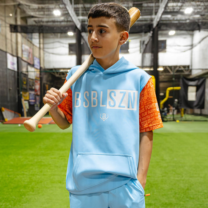 Youth model wearing blue youth short sleeve hoodie with "BSBL-SZN V3 Short Sleeve Youth" design