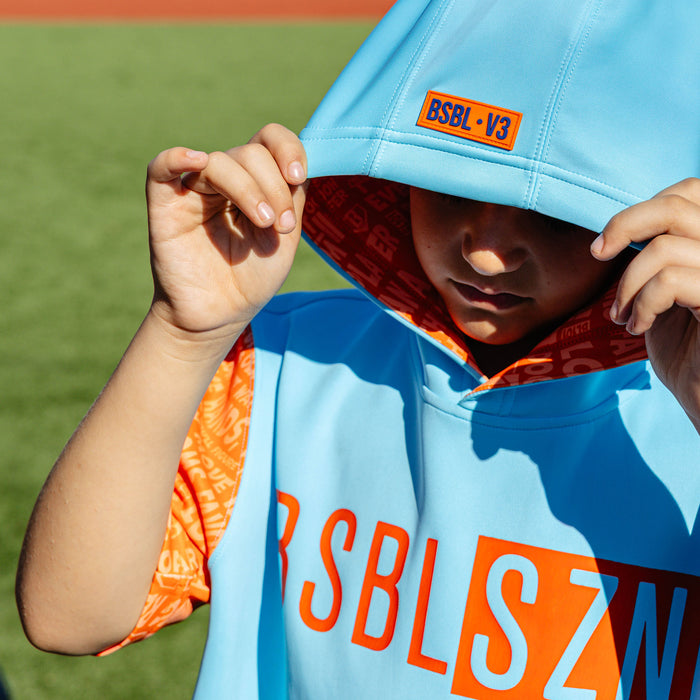 Youth model wearing blue youth short sleeve hoodie with "BSBL-SZN V3 Short Sleeve Youth" design
