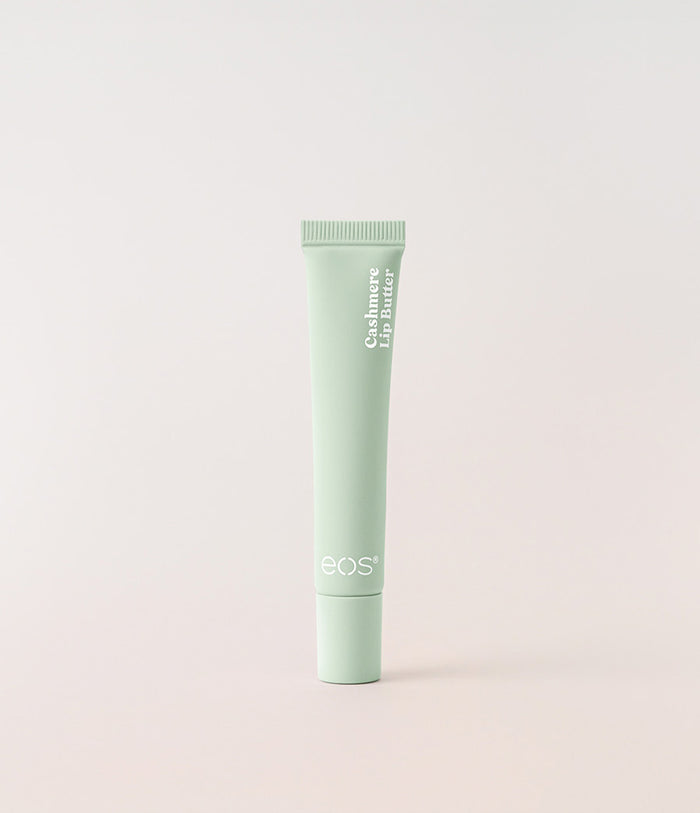 Green tube of eos lip balm on a light gray background