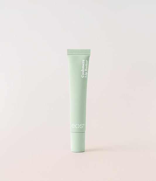Green tube of eos lip balm on a light gray background