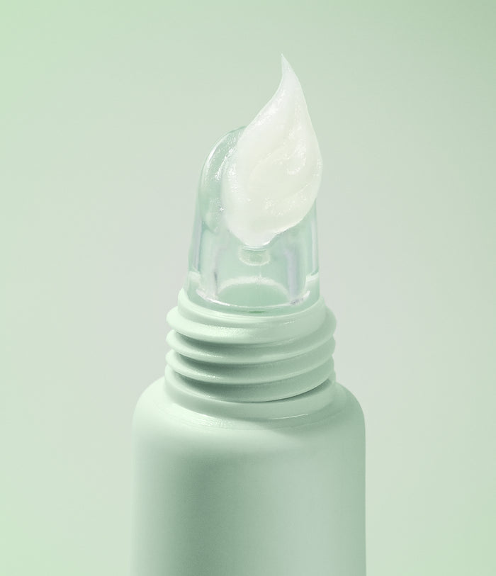 Mint green bottle with a dropper on a light green background