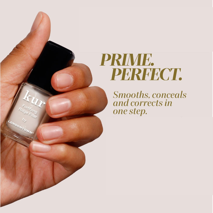 A hand holds a bottle of LONDONTOWN Fortifying Ridge Filler, highlighting its smoothing, concealing, and correcting benefits for nails.