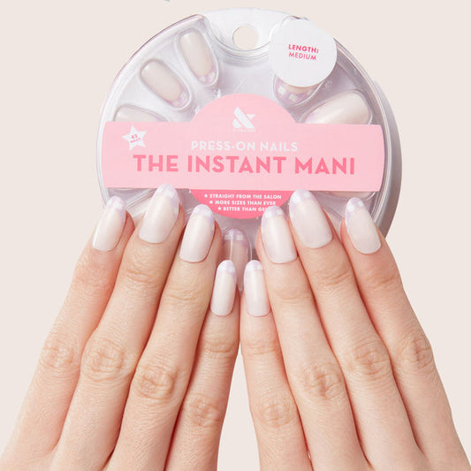 Hands wearing Gingham French - Press-On | Medium | Oval with medium oval nails and soft lavender gingham French tips