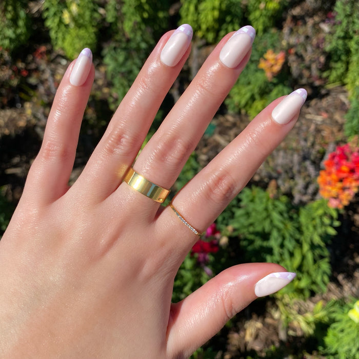 Hand outdoors showing Gingham French - Press-On | Medium | Oval with soft lavender gingham tips on medium oval nails