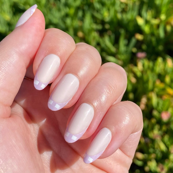 Hand featuring Gingham French - Press-On | Medium | Oval with soft lavender gingham tips on smooth medium oval nails manicure