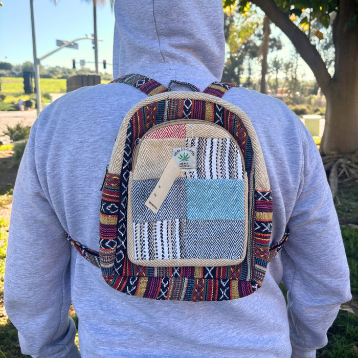 Person wearing a colorful patterned backpack outdoors