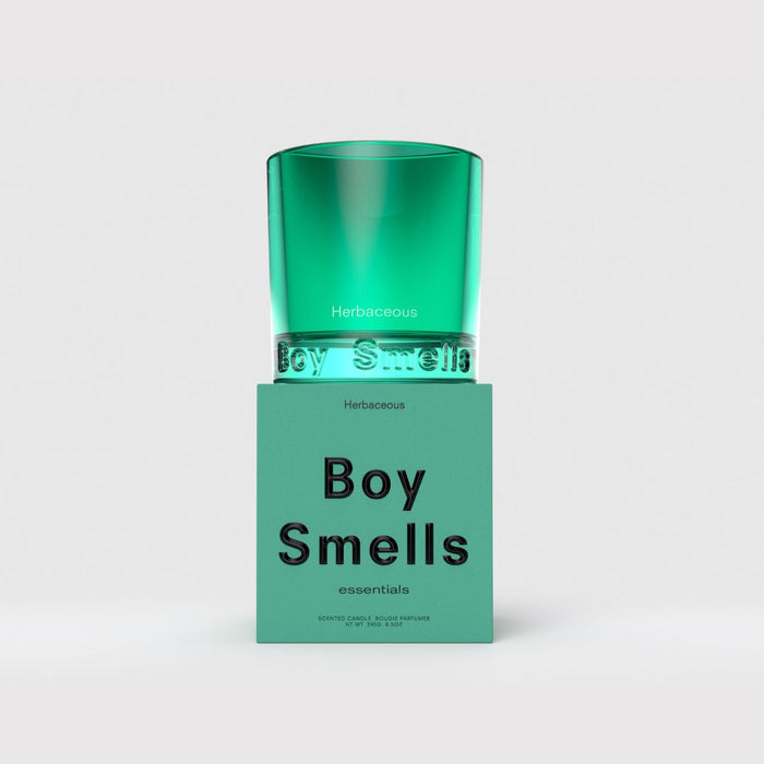 Green glass candle in teal jar with 'Herbaceous' and 'Boy Smells' label