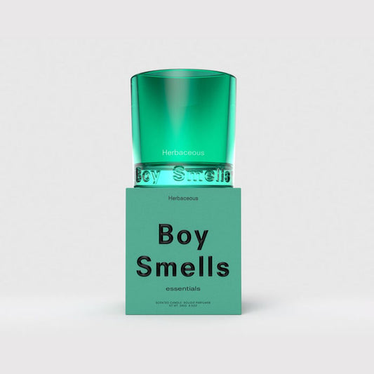 Green glass candle in teal jar with 'Herbaceous' and 'Boy Smells' label