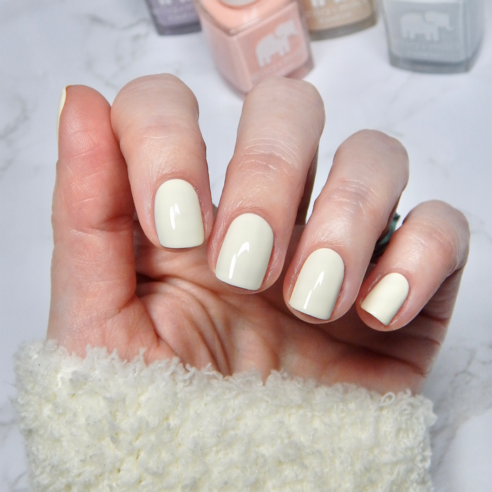 Icing on the Cake powder cream nail polish manicure on a light skin tone with a white sweater
