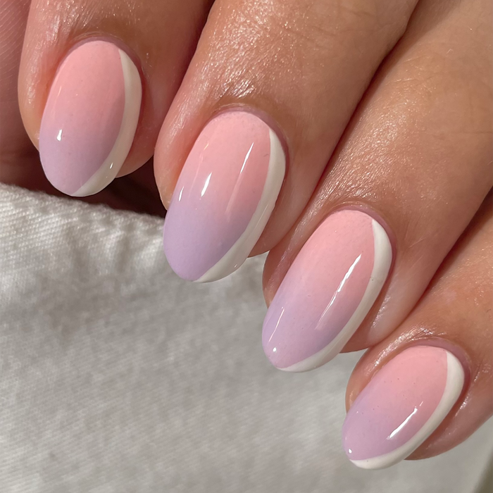 Icing on the Cake cream nail polish close-up on a light skin tone with a white sweater