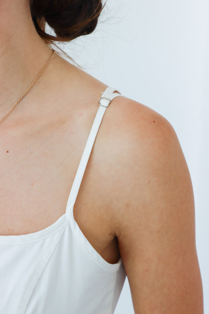 girl wearing white long dress with black bow details