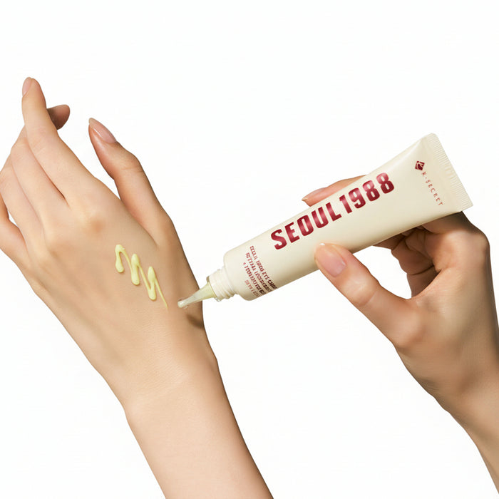 Hand applying cream from a 'Seoul 1988' tube to another hand with a beige background
