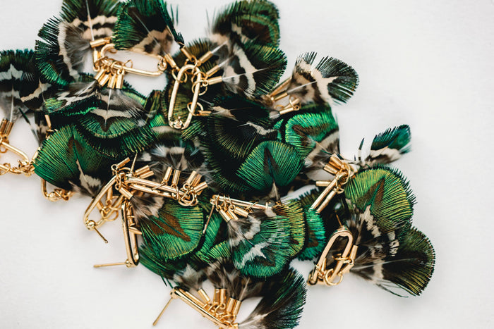 St Armands Designs of Sarasota mallard feather tassel earrings with gold hooks showcasing delicate feather details and tassel accents.
