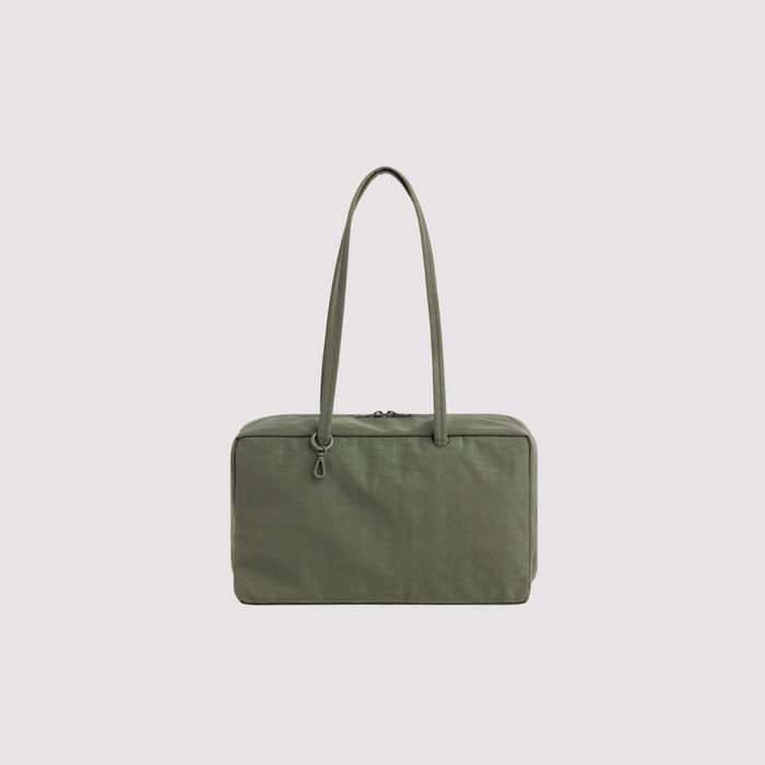 Medium nylon bowler bag in olive green with top zipper and short carry handles.