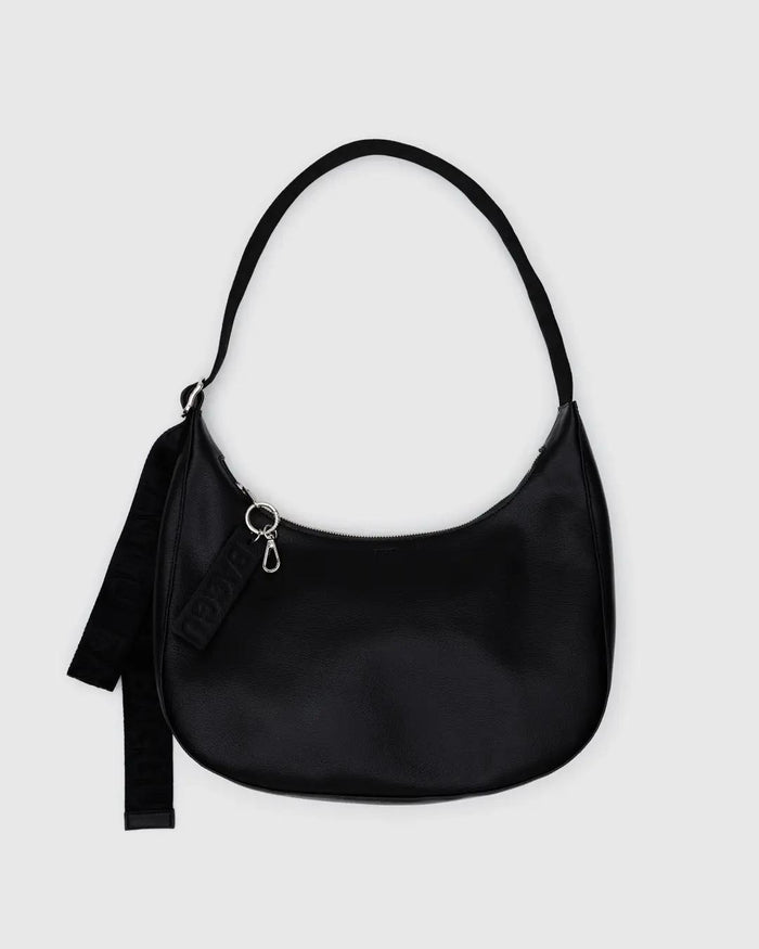 Medium recycled leather crescent bag in black, zip top, shoulder strap with tassel