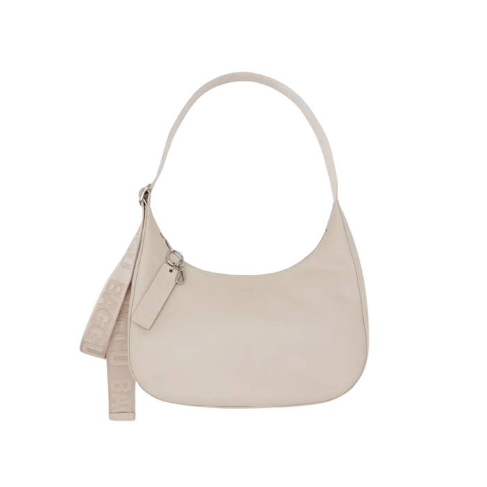 Medium recycled leather crescent bag in light stone, zip top, shoulder strap with tassel