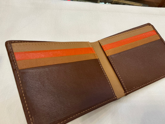 Men's bifold wallet by ili New York, showcasing leather material with card slots and a sleek, classic design.