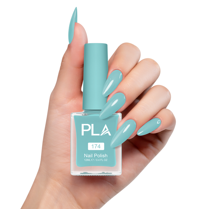 Hand holding a turquoise nail polish bottle with matching nails on a white background