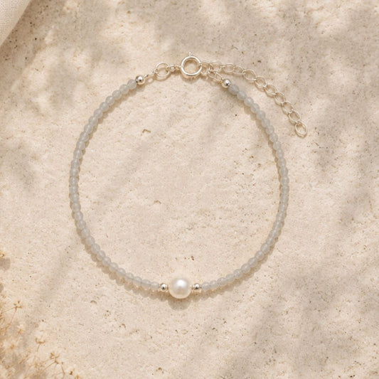 Pearl bracelet on a sandy surface