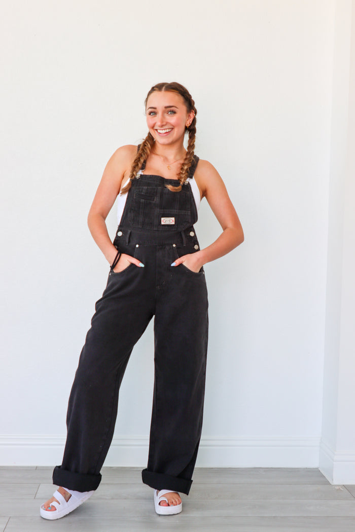 girl wearing black denim overalls