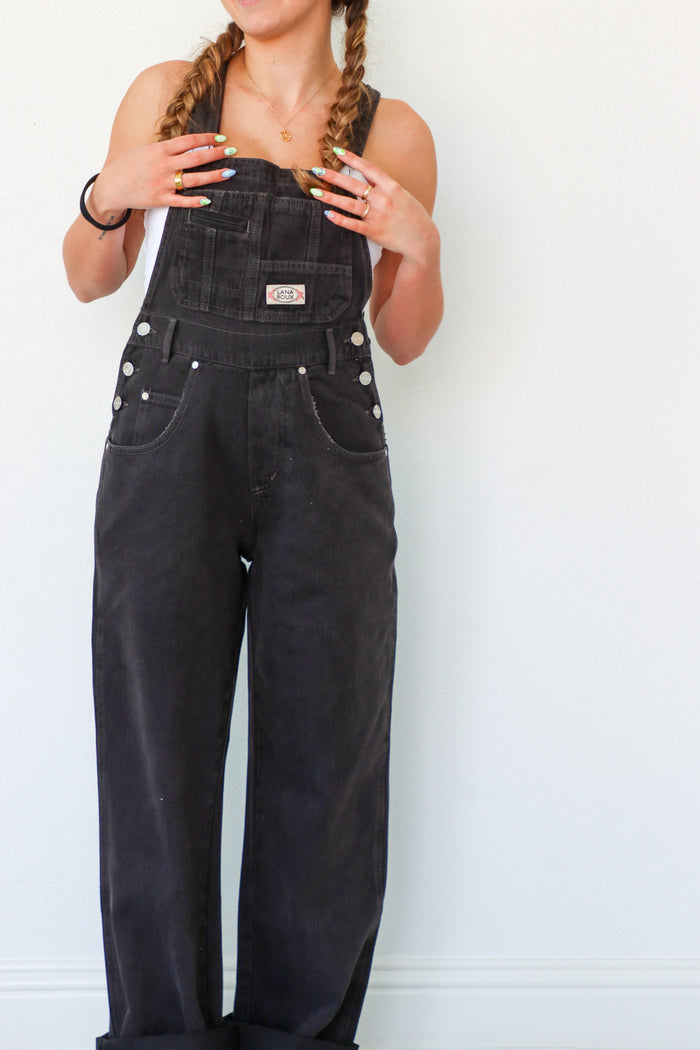 girl wearing black denim overalls