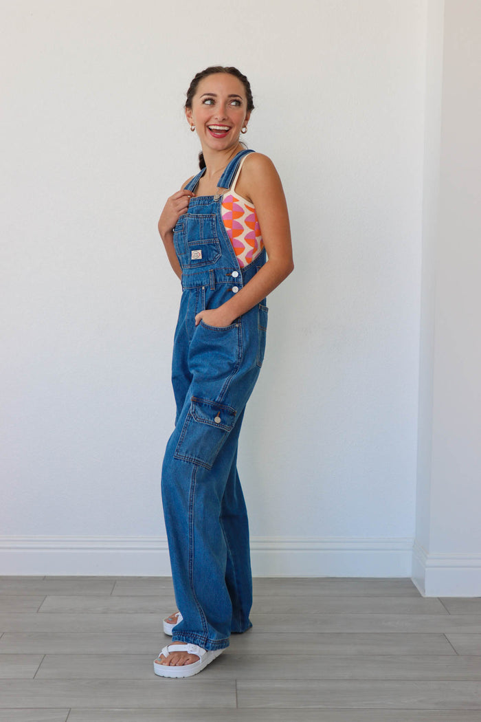 girl wearing blue denim long overalls