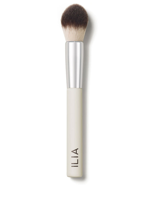 A close-up of the Precision brush with a white handle and dense, dual-toned bristles.