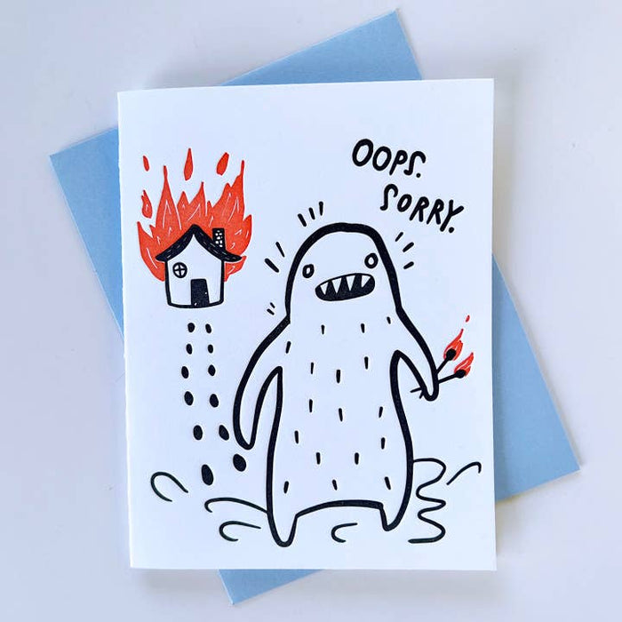 Everyday greeting card with cartoon monster, flames, and text reading “OOPS SORRY”
