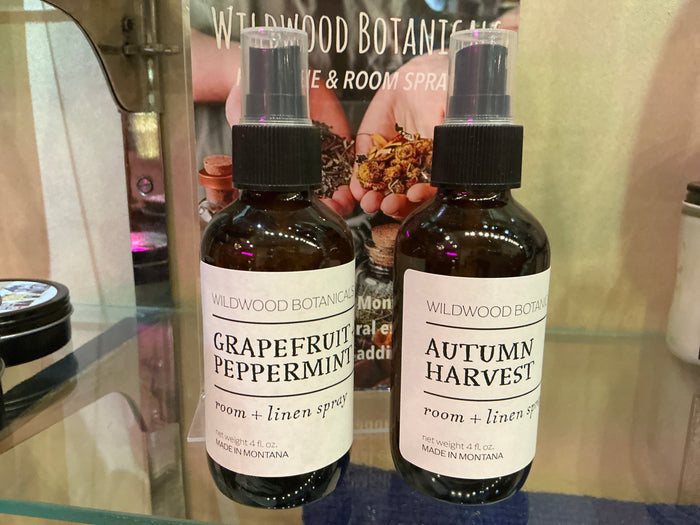 Wildwood Botanicals room and linen spray bottle of airfreshener with floral and herbal scent, ready for freshening up rooms.