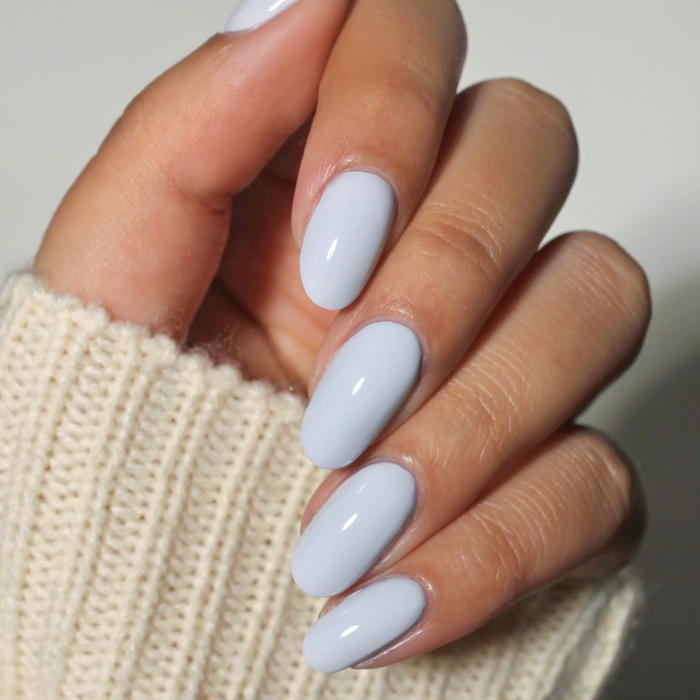 Royal Tea pastel grey blue nail polish manicure on a medium skin tone with a white sweater
