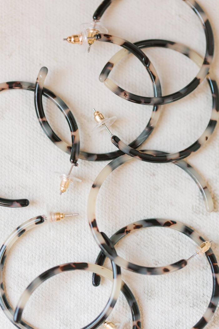 Gold-tone skinny blonde tortoise hoop earrings with a sleek, minimalist design from St Armands Designs of Sarasota.