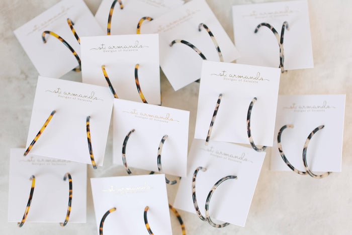 Skinny blonde tortoise hoop earrings by St Armands Designs of Sarasota, featuring slim, stylish tortoise shell hoops.