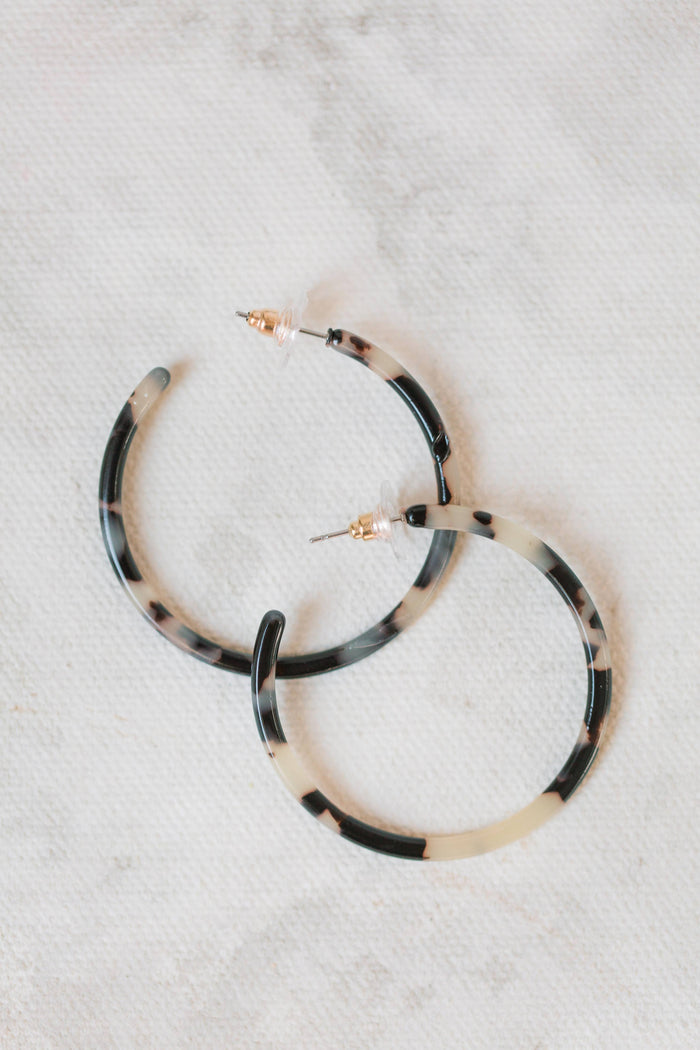 Skinny blonde tortoise hoop earrings by St Armands Designs of Sarasota, showing gold-tone hoops with tortoise pattern.