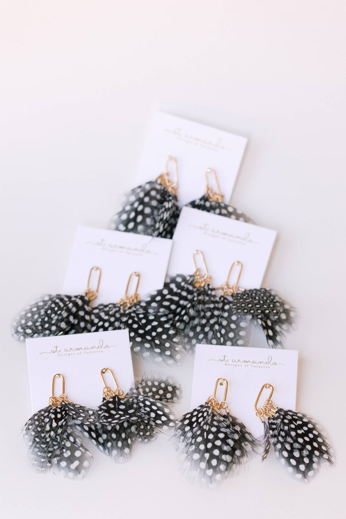 Spotted feather earrings by St Armands Designs of Sarasota, featuring lightweight feathers with black spots on a silver hook.