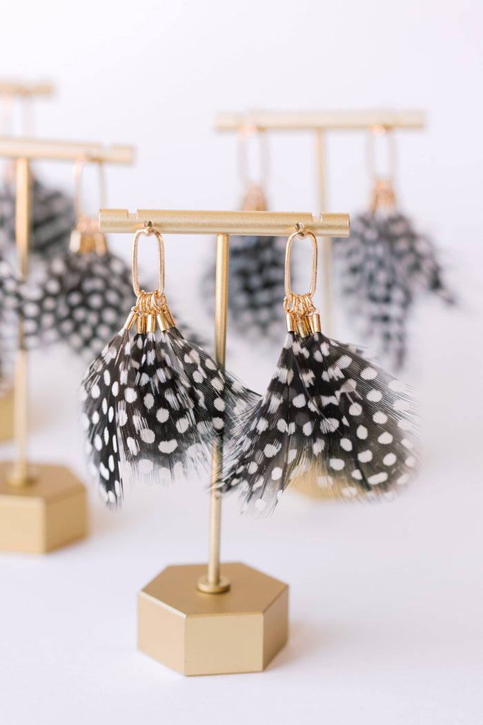 Spotted feather earrings by St Armands Designs of Sarasota, featuring lightweight feather dangles with black and white spots.