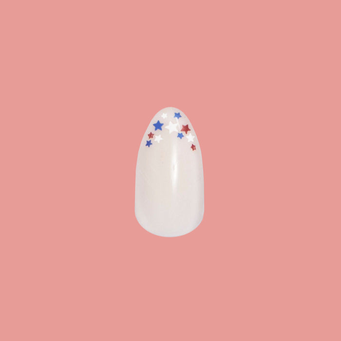 Star Showers | Almond | Medium press-on nail featuring tiny red, white, and blue stars on almond-shaped French tip manicure