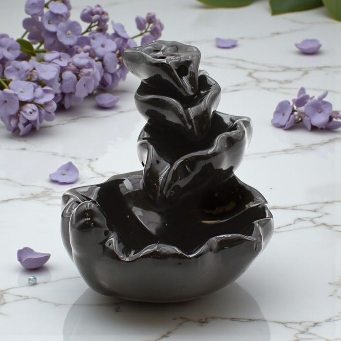 Triple Lily Leaf Backflow Incense Burner with purple flowers on a marble surface