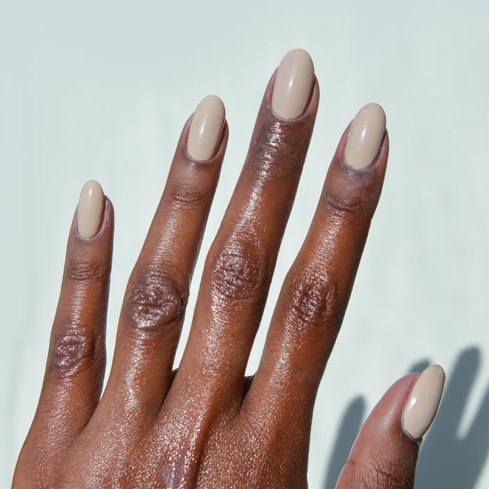 Whipped Chai light tan nail polish manicure on a deep skin tone